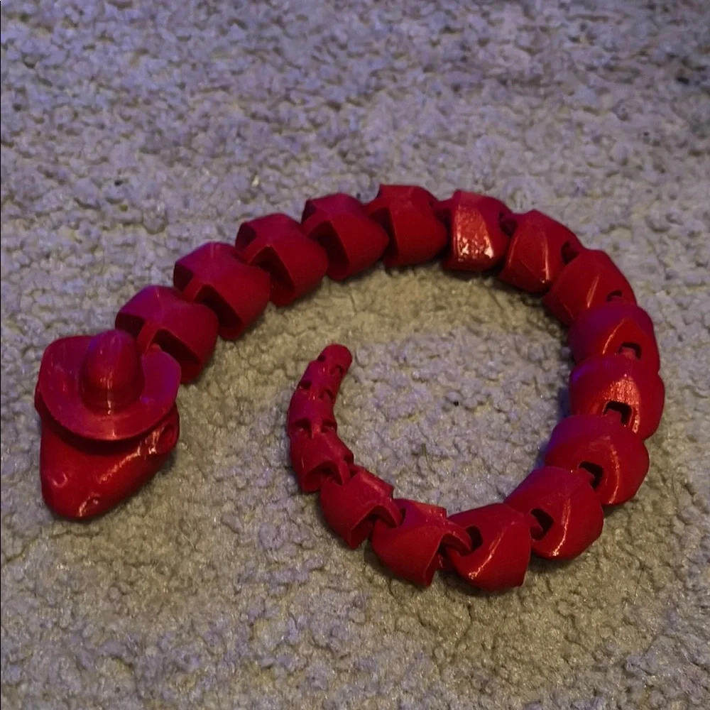 Red 3d printed snake with cowboy hat